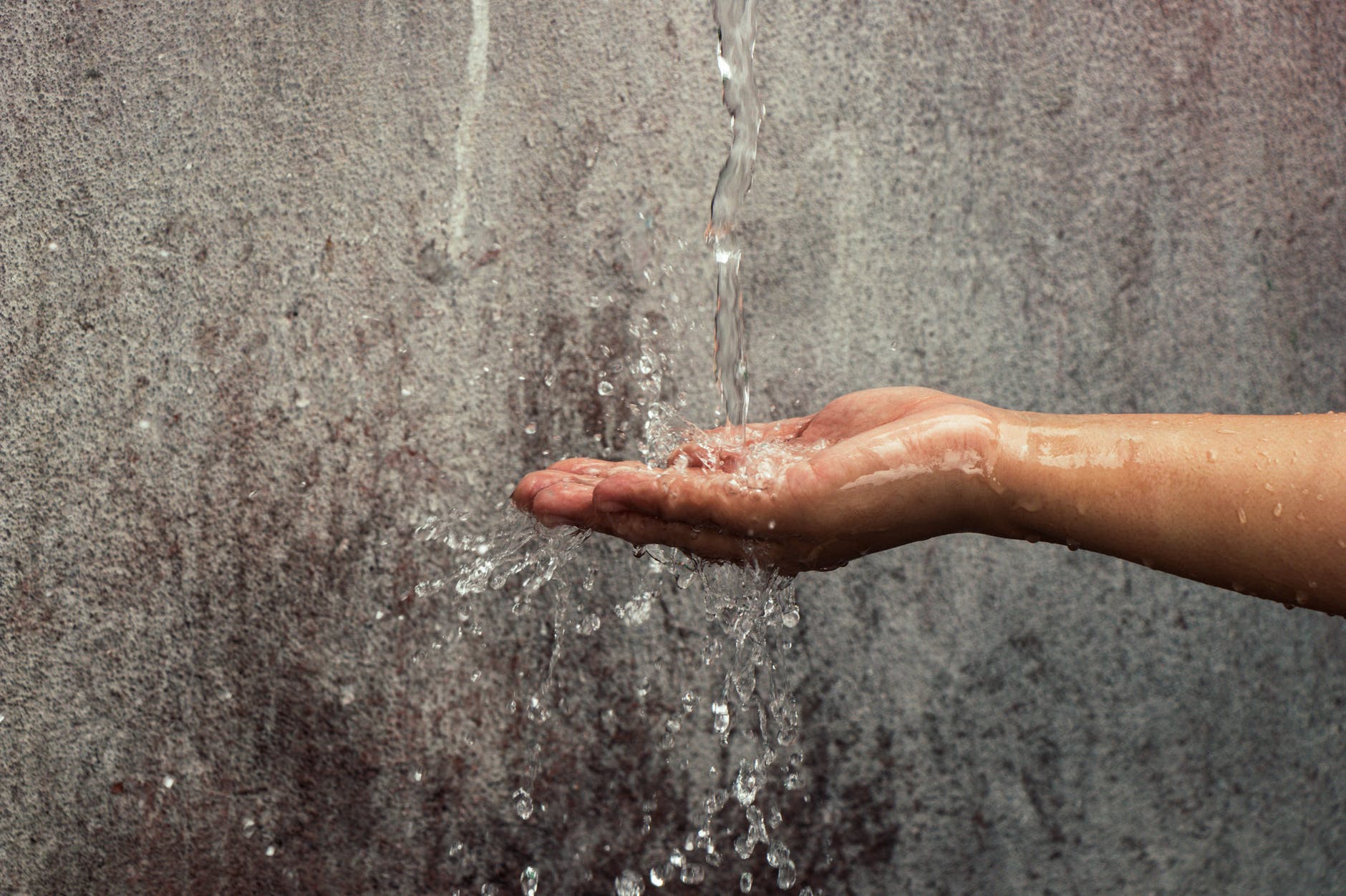 hand catching flowing water